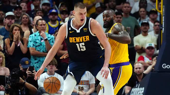 Nuggets’ Nikola Jokić posts up Lakers’ LeBron James.